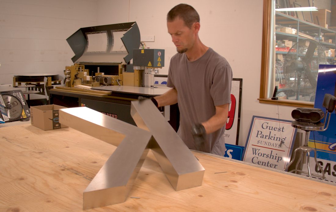 Excel Sign Company craftsman fabricating a dimensional metal letter in the Clovis shop