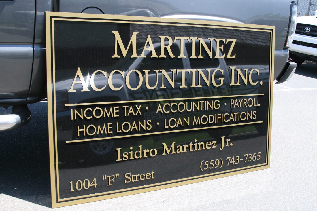 Illuminated channel letters next to a lighted cabinet sign